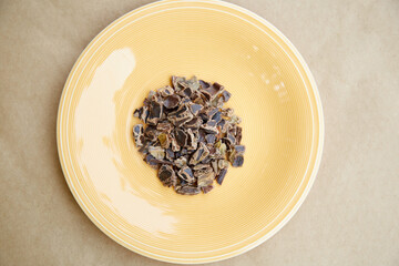 Carob - plant-based alternative - natural product on the plate. Organic antioxidants and protein. Top view.