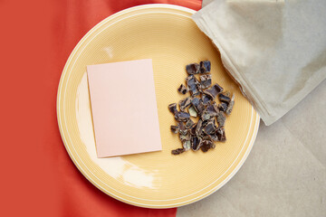 Carob - coffee alternative - organic product on the plate. Natural plant-based caffeine antioxidants. Mock up of business card