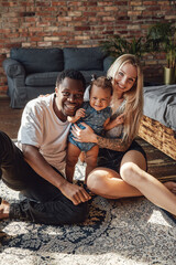 Happy interracial family posing together looking at camera
