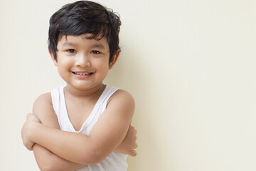 Cute Asian child little Thai boy 4 year old wearing a red sweater he have smile laugh face happy kid concept.  