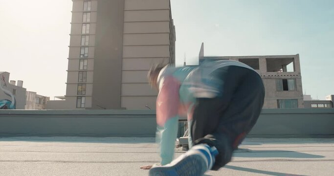 dancing man breakdancing on rooftop in city hip hop dancer practicing dance routine with hand stand performing freestyle moves in city