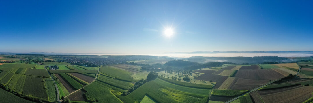 panoramc aerial view with fields and mist