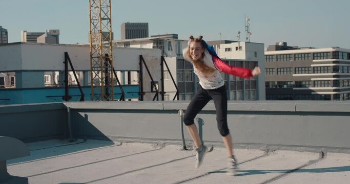 funny woman dancing on rooftop celebrating enjoying silly dance having fun crazy dancer girl in city