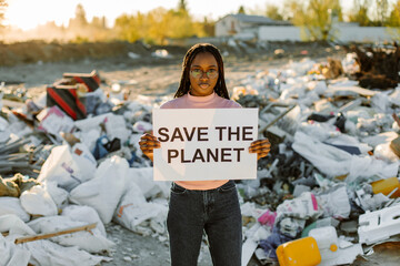 African American woman holding save the planet sign - Powered by Adobe
