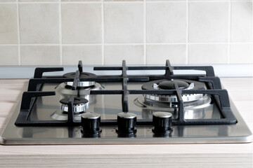 Modern new stainless steel gas hob on the countertop