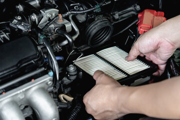 Hand a man input new air filter of car engine in engine room basic concept in maintenance of a car