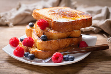 plate of french toasts with fresh berries