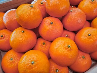 Mandarin oranges on stall in supermarket. Organic oranges fruits.