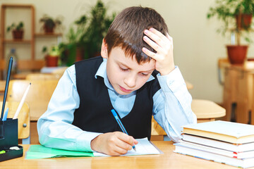 Serious schoolboy in the classroom. Primary school student. Back to school.