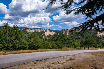 Fototapeta na wymiar A road to the mountains and sand pyramids near Melnik
