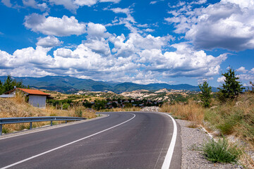 Empty road near Melnik mountains towards the sky
