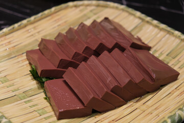 duck blood in bamboo plate. Raw food for Chinese hotpot