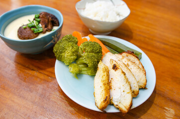 Diet menu for weight loss. Grilled chicken, poached eggs and boiled vegetables.