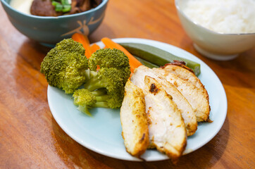Diet menu for weight loss. Grilled chicken, poached eggs and boiled vegetables.