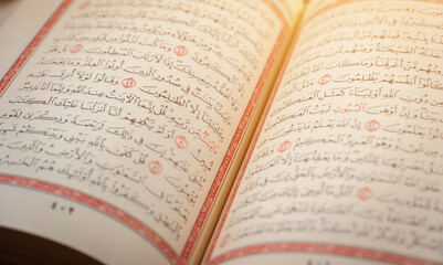 Quran (Koran) - close up of holy book of Muslims, with shining light.