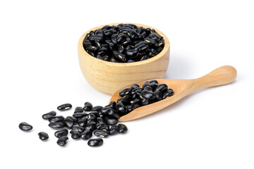 Black beans (Urad dal, black gram, vigna mungo bean) in wooden bowl and scoop isolated on white background. 