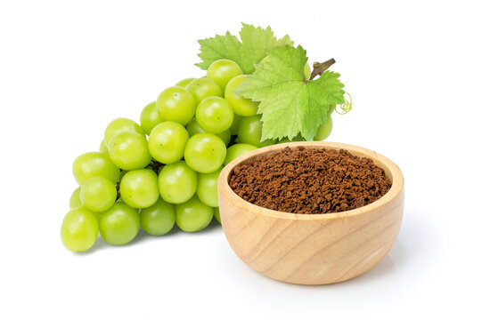 Grape extract flour (opc grape powder) in wooden bowl and fresh grapes isolated on white background.