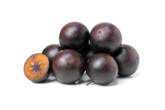 Flacourtia indica fruit with half sliced isolated on white background.