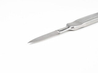 the steel medical scalpel on a white background