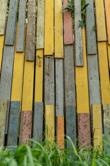 Background texture of colorful old wooden fence. Colored wooden planks, wooden surface, wall or floor. Copy space.