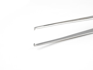 straight steel surgical tweezers with fang on a white background