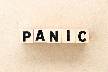 Alphabet letter block in word panic on wood background