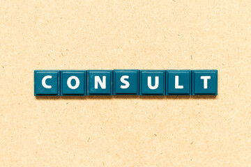 Obraz premium Tile alphabet letter in word consult on wood background