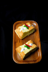 cheese chiffon cake on black background