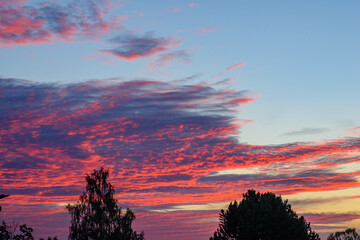 The clouds of the morning sky are painted in scarlet