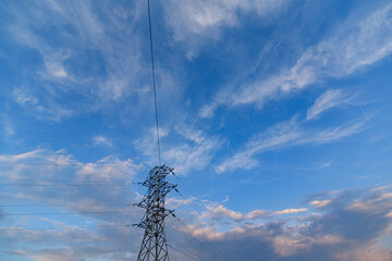 The support of the power line against the background of the morning cloudy sky