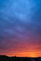 Sunrise turns the clouds pink and red