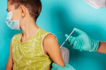 Doctor injects vaccine to a child against covid19 coronavirus