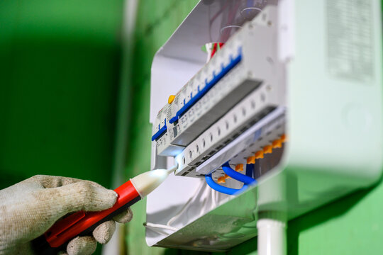 Close-up of the control panel circuit breaker. An electrician tests old wiring and the installation of switches and electrical systems in homes and buildings.