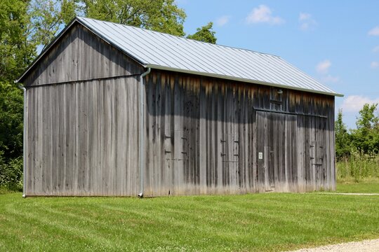 A side angle view of the old wood barn in the country.