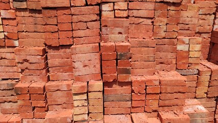 photo of a pile of red bricks being prepared for the construction of a house