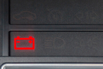 Car battery light in dashboard warning about problems. Vehicle panel with red indicator electricity...