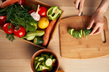 cutting fresh vegetables on a cutting board kitchen healthy eating at home