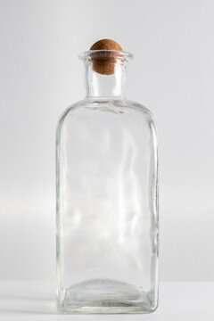 clear glass bottle with round cap