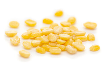 Micro close-up and details of Organic Indian splitted yellow Gram (Vigna radiata) or split yellow moong dal isolated over white background.