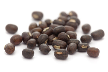 Micro close-up and details of Organic Indian whole black urad dal (Vigna mungo) isolated over white background.