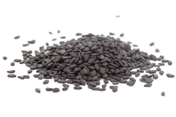 Micro close-up and details of Organic Indian Sesame seeds (Sesamum indicum) or Black Til with black shell isolated over white background.