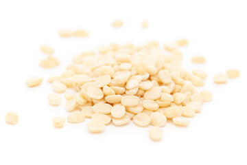 Micro close-up and details of Organic Indian splitted white urad dal (Vigna mungo) isolated over white background