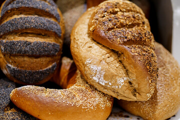 Various bread on shelf and in basket, Homemade bread. Fresh baked bread in baker shop.