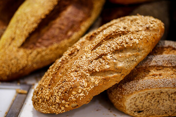 Closeup of loaf of bread with various seeds, Homemade bread. Fresh baked bread in baker shop.
