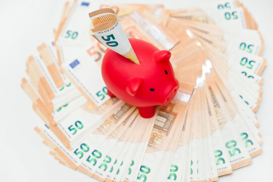 Bunch of Euro's. Close-up. Saving money. Keeping savings at home. Finance, savings, investing. Money management at home. Piggy bank with Euro out from it. Financial business concept.