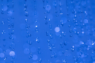 Naklejka na ściany i meble water drops in the air on blue background