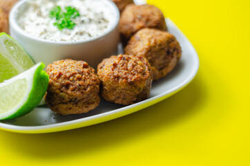 Falafels, gently spiced blend of sweet potato, chickpeas and onion with a sour dip
