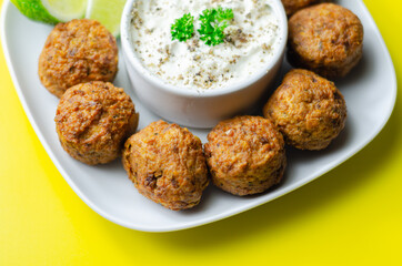 Falafels, gently spiced blend of sweet potato, chickpeas and onion with a sour dip