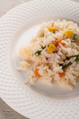 rice porridge with vegetables on a white plate