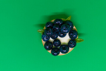 Shortbread cake with blueberries on a green background